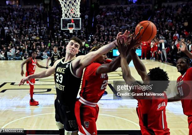 Matthew Marsh of the Wake Forest Demon Deacons battles Greg Gantt of the North Carolina State Wolfpack for a rebound during their game at Lawrence...