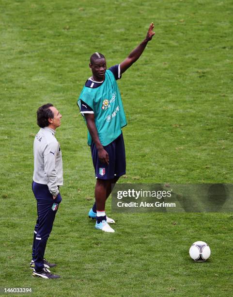 Mario Balotelli of Italy and head coach Cesare Prandelli attend a UEFA EURO 2012 training session ahead of their Group C match against Spain at the...