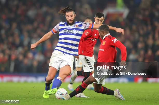 Andy Carroll of Reading is tackled by Tyrell Malaciaof Manchester United during the Emirates FA Cup Fourth Round match between Manchester United and...