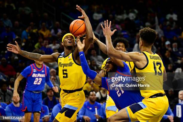 Da'Sean Nelson of the DePaul Blue Demons looses the basketball in the second half against Chase Ross of the Marquette Golden Eagles at Wintrust Arena...