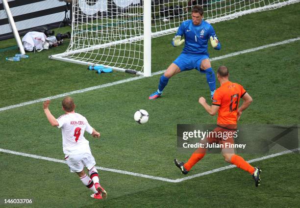 Michael Krohn-Dehli of Denmark scores their first goal past Maarten Stekelenburg of Netherlands during the UEFA EURO 2012 group B match between...