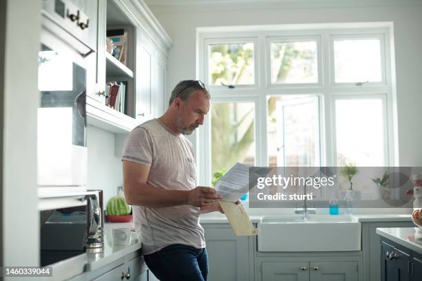 opening a bill at home - reading letter stock pictures, royalty-free photos & images