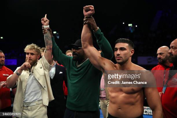 Boxer Derek Chisora holds the hands of Jake Paul and Tommy Fury as they face off, ahead of their upcoming fight on the 26th of February in Diriyah in...
