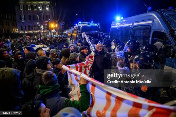 Demonstrators face Italian Police officers during a demonstration against the '41 bis' regime for Alfredo Cospito, on January 28, 2023 in Rome,...