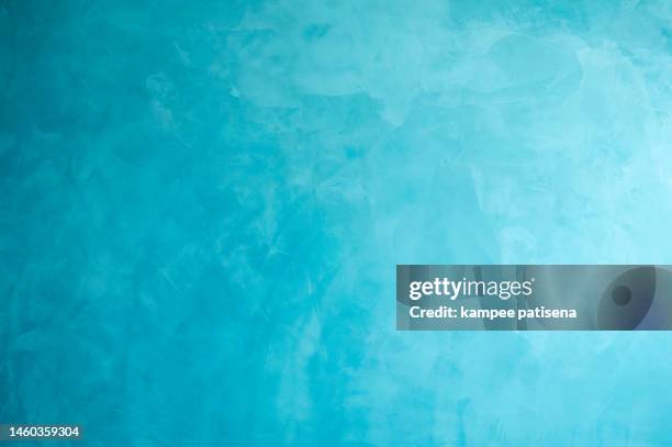 close-up of plastered concrete wall painted in blue - background paint room stock-fotos und bilder