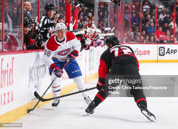 Jesse Ylonen of the Montreal Canadiens chips the puck past Thomas Chabot of the Ottawa Senators during the first period of the game at Canadian Tire...