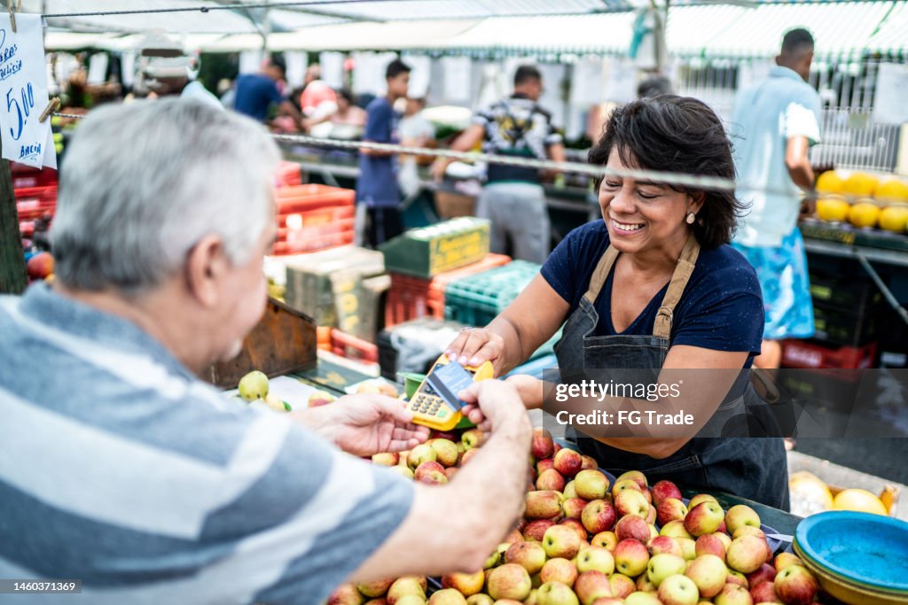 Customer paying with credit card on a street market