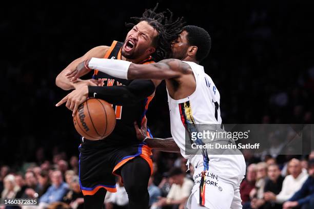 Jalen Brunson of the New York Knicks is fouled by Kyrie Irving of the Brooklyn Nets during the fourth quarter of the game at Barclays Center on...