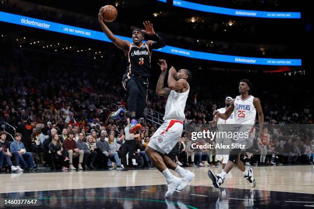 Aaron Holiday of the Atlanta Hawks goes up fort a short over Kawhi Leonard of the LA Clippers during the first half at State Farm Arena on January...