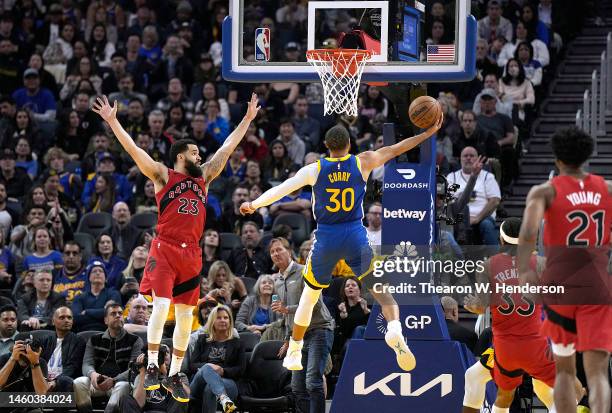 Stephen Curry of the Golden State Warriors goes up for a layup over Fred VanVleet of the Toronto Raptors during the second quarter at Chase Center on...