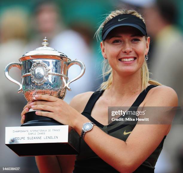Maria Sharapova of Russia celebrates with the Coupe Suzanne Lenglen after the women's singles final against Sara Errani of Italy during day 14 of the...