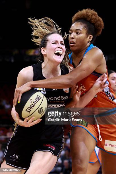 Keely Froling of the Flames drives to the basket defended by Tianna Hawkins of the Fire during the round 12 WNBL match between Sydney Flames and...