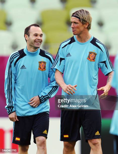Andres Iniesta of Spain chats with Fernando Torres during a UEFA EURO 2012 training session ahead of their Group C match against Italy at the...