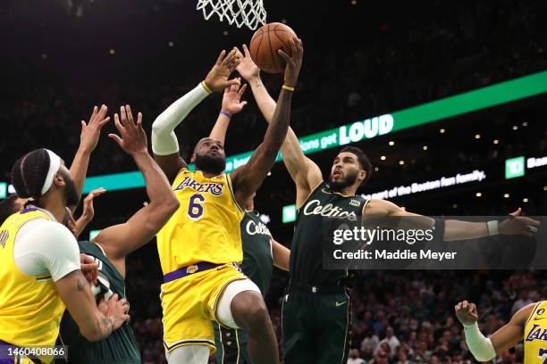 Jayson Tatum of the Boston Celtics defends LeBron James of the Los Angeles Lakers in the final shot of regulation play during the fourth quarter at...