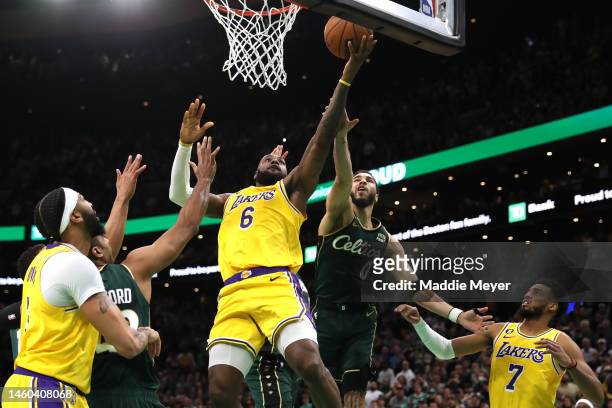 Jayson Tatum of the Boston Celtics defends LeBron James of the Los Angeles Lakers in the final shot of regulation play during the fourth quarter at...