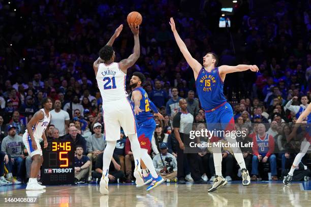 Joel Embiid of the Philadelphia 76ers shoots the ball against Nikola Jokic of the Denver Nuggets at the Wells Fargo Center on January 28, 2023 in...