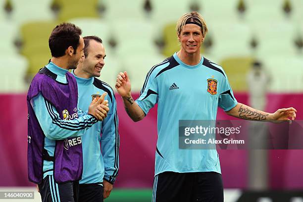 Fernando Torres of Spain chats with team mates Andres Iniesta and Juanfran during a UEFA EURO 2012 training session ahead of their Group C match...
