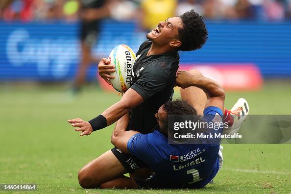 Roderick Solo of New Zealand is tackled during the 2023 Sydney Sevens ...