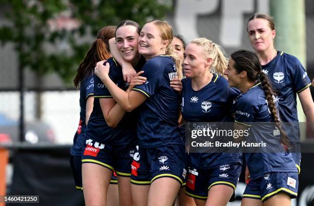 Emily Clegg of the Phoenix is congratulated by team mates after scoring a goal during the round 12 A-League Women's match between Brisbane Roar and...