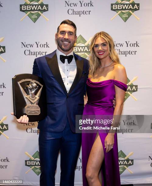 Justin Verlander poses with his wife Kate Upton and his American League Cy Young Award during the 2023 Baseball Writers' Association of America...