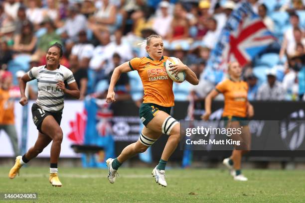 Maddison Levi of Australia makes a break before scoring a try during the 2023 Sydney Sevens match between Australia and Fiji at Allianz Stadium on...