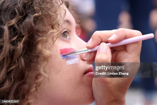 Serbian flag is painted on a spectator face ahead of the Men’s Singles Final between Stefanos Tsitsipas of Greece and Novak Djokovic of Serbia during...