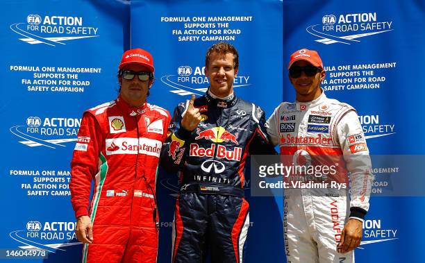 Pole sitter Sebastian Vettel of Germany and Red Bull Racing celebrates in parc ferme with second placed Lewis Hamilton of Great Britain and McLaren...