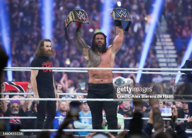 Roman Reigns celebrates after winning the WWE and Universal Championship match during the WWE Royal Rumble at the Alamodome on January 28, 2023 in...