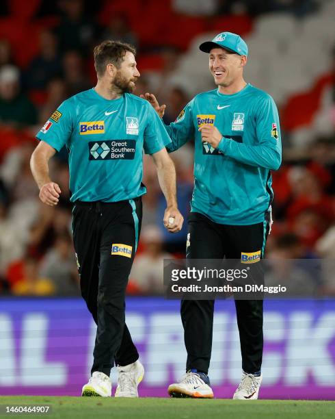 Michael Neser and Marnus Labuschagne of the Heat celebrate a wicket makes a catch during the Men's Big Bash League match between the Melbourne...