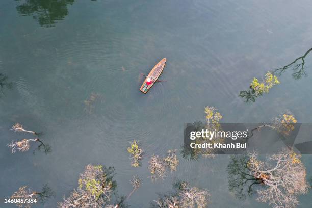 old fisherman floating on the lake, the photo was taken by drone - vietnam spring stock pictures, royalty-free photos & images