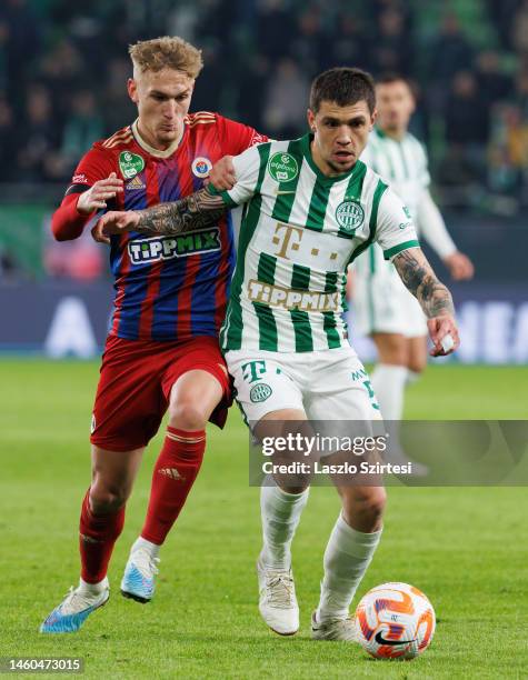 Dominik Cipf of Vasas FC challenges Muhamed Besic of Ferencvarosi TC during the Hungarian OTP Bank Liga match between Ferencvarosi TC and Vasas FC at...