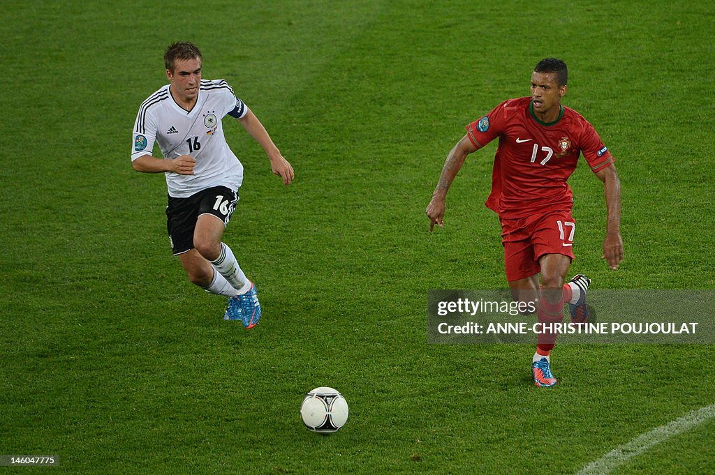 German defender Philipp Lahm (L) vies wi