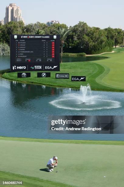 Luke Donald of England lines up a putt on the 18th green during the Third Round on Day Four of the Hero Dubai Desert Classic at Emirates Golf Club on...