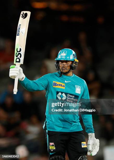 Usman Khawaja of the Heat celebrates after scoring half a century during the Men's Big Bash League match between the Melbourne Renegades and the...