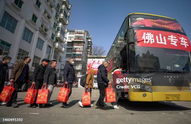 Migrant workers line up to get on a chartered bus on January 29, 2023 in Danzhai County, Qiandongnan Miao and Dong Autonomous Prefecture, Guizhou...