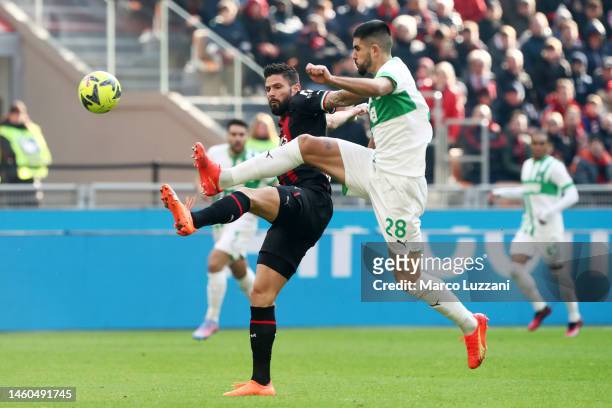 Olivier Giroud of AC Milan is challenged by Martin Erlic of US Sassuolo during the Serie A match between AC MIlan and US Sassuolo at Stadio Giuseppe...