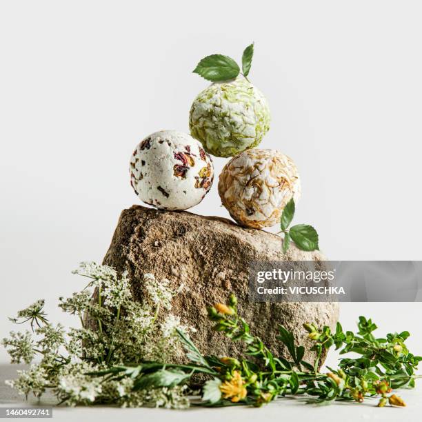 handmade herbal bath bombs on natural stone - bath bomb stock pictures, royalty-free photos & images