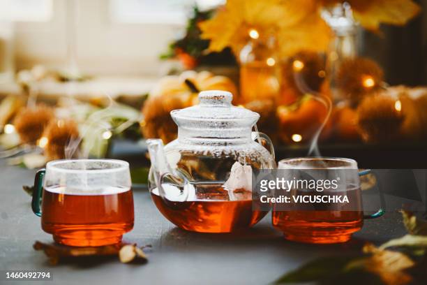 black tea in glass teapot and cups on rustic table - black tea stock pictures, royalty-free photos & images