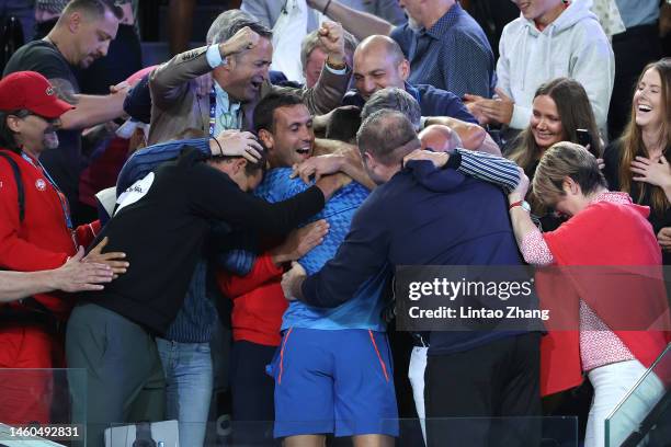 Novak Djokovic of Serbia celebrates winning championship point with his player box in the Men’s Singles Final against Stefanos Tsitsipas of Greece...