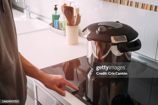 man using high pressure pot in kitchen - pressure cooker stock-fotos und bilder