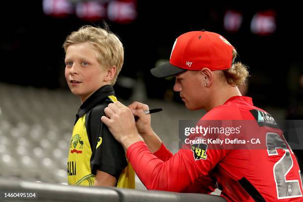 Jake Fraser-McGurk of the Renegades takes time to sign for a supporter on his way out of the arena after the loss during the Men's Big Bash League...