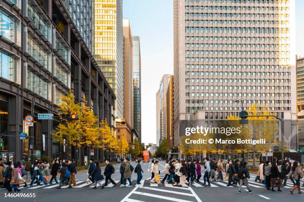 commuters walking in station square in tokyo station, jaan - tokyo crossing stock pictures, royalty-free photos & images