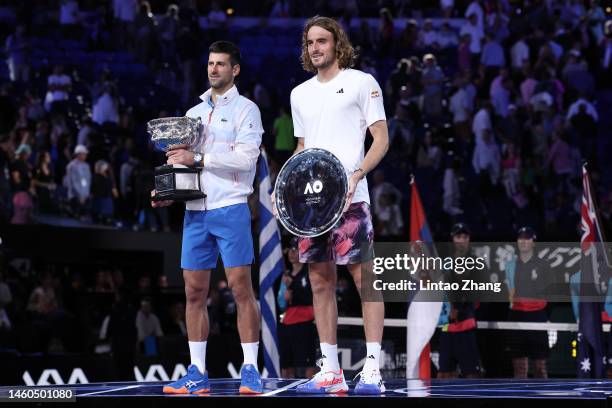 Novak Djokovic of Serbia poses with the Norman Brookes Challenge Cup alongside Stefanos Tsitsipas of Greece after the Men's Singles Final match...