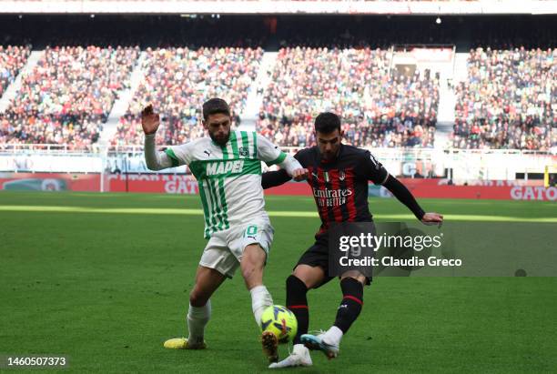 Théo Hernández of AC Milan is tackled by Domenico Berardi of US Sassuolo during the Serie A match between AC MIlan and US Sassuolo at Stadio Giuseppe...