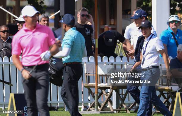 Patrick Reed of The United States walks past Rory McIlroy of Northern Ireland on the driving range ahead of their Third Round on Day Four of the Hero...