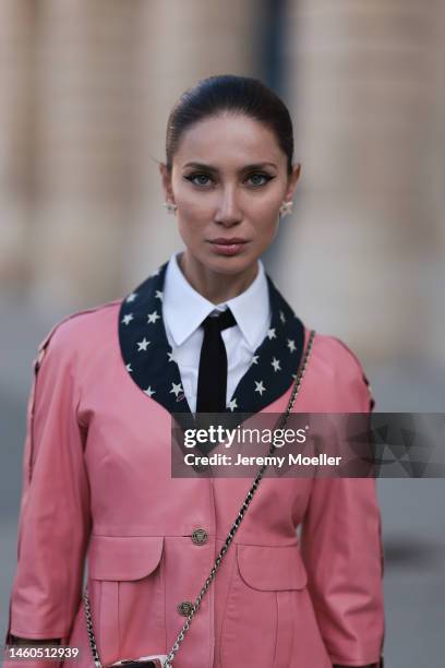 Sabina Jakubowicz seen wearing rose leather jacket, Chanel crossbody micro bag, white flannel and black tie before Chanel show during the Paris...