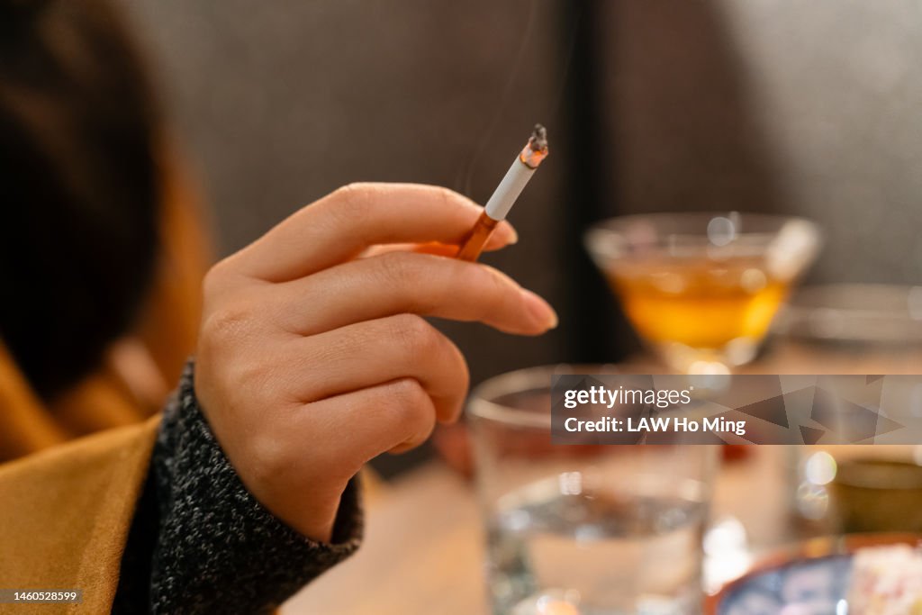 A woman smoking in a tavern