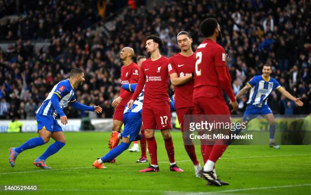 Curtis Jones of Liverpool reacts as Kaoru Mitoma of Brighton & Hove Albion celebrates after scoring the team's second goal during the Emirates FA Cup...