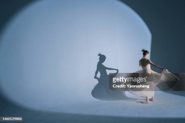 young asian woman dancing in graceful pose - ballet performance stock pictures, royalty-free photos & images