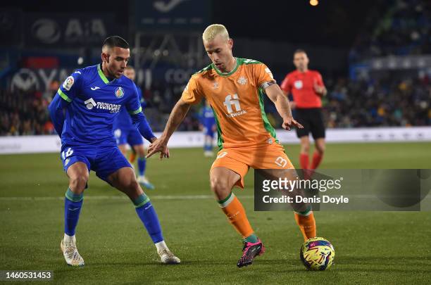 Sergio Canales of Real Betis shields the ball from Angel Algobia of Getafe CF during the LaLiga Santander match between Getafe CF and Real Betis at...